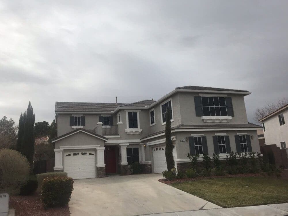 Solar screens on the west-facing windows of a two-story home