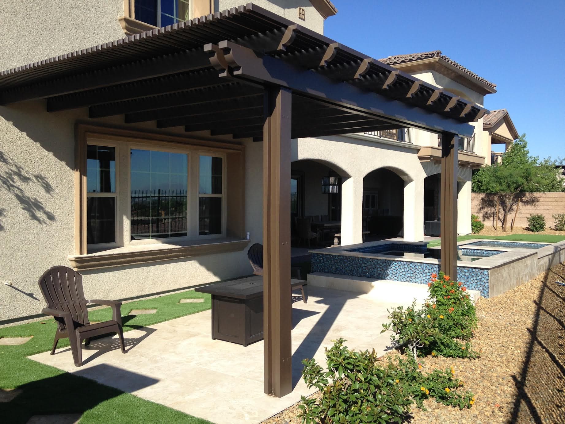 Dark-brown Alumawood combo patio cover over an outdoor kitchen and pool in Bakersfield