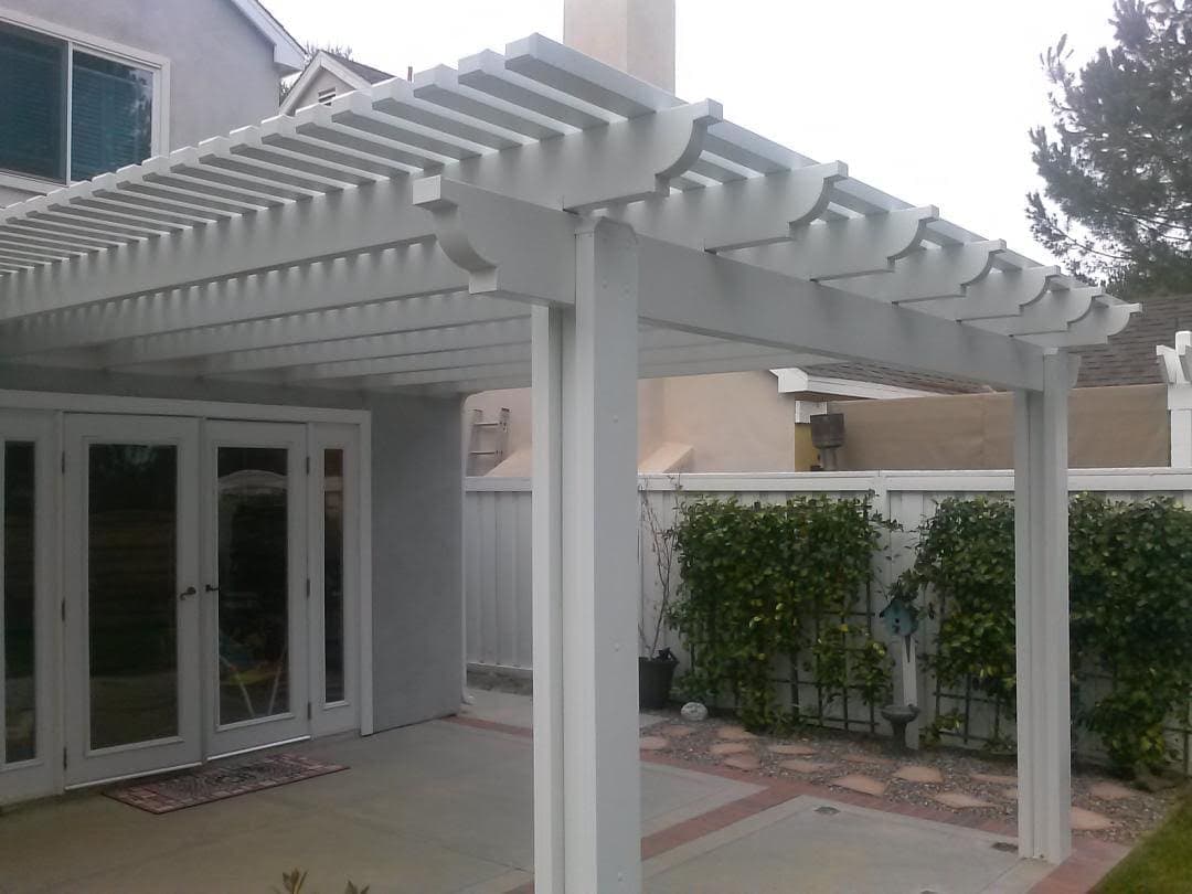 White lattice patio cover beside a back door