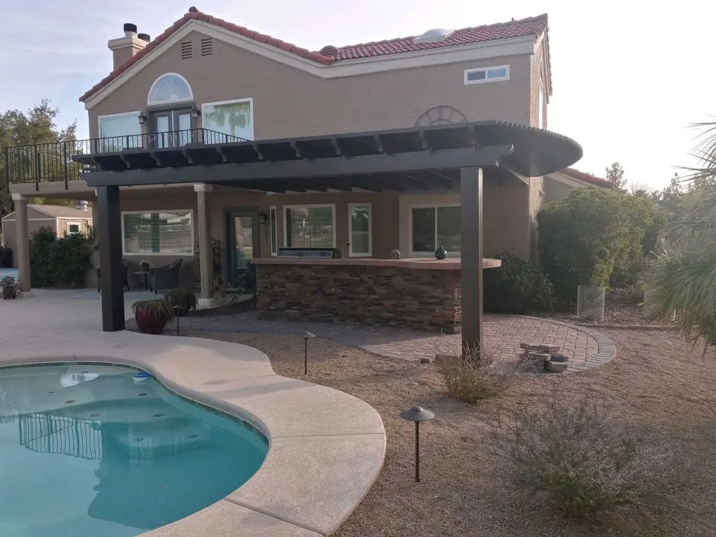 Backyard patio cover installation next to pool